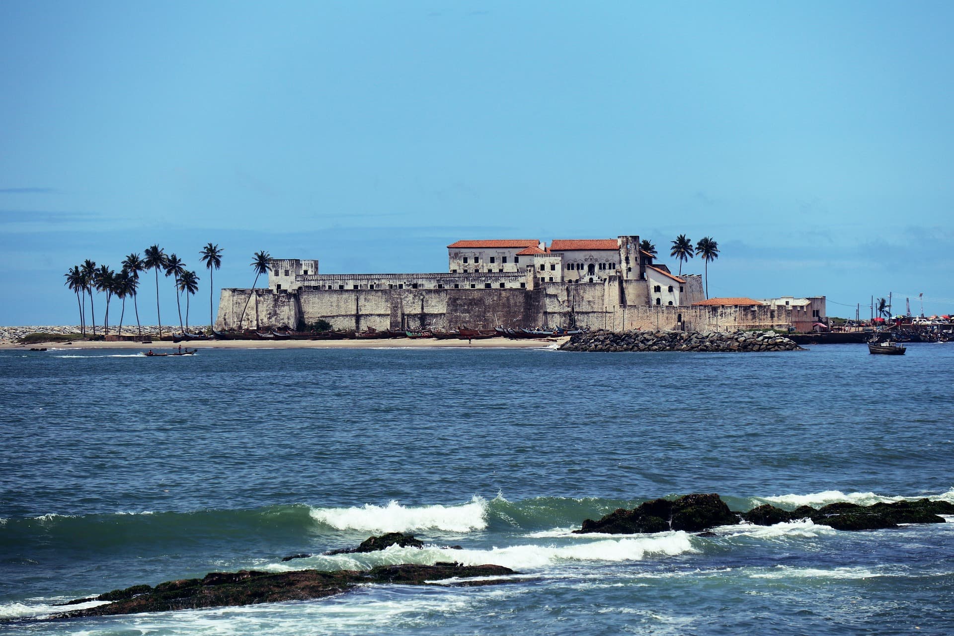 A castle in the distance surrounded by bright waters